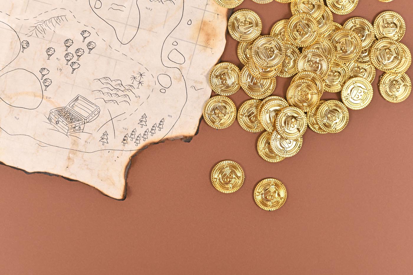 A hand-drawn treasure map with toy gold coins